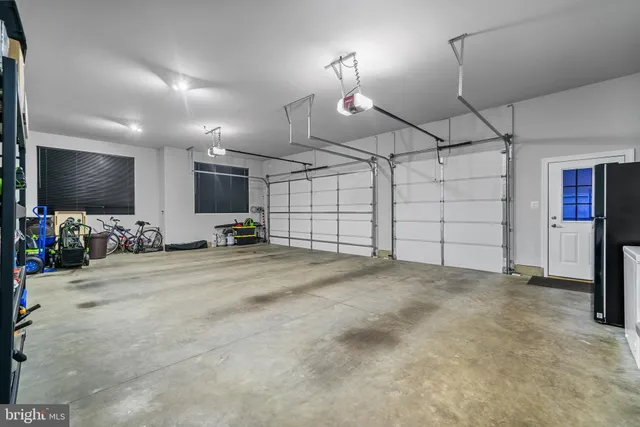 a living room with furniture and large windows