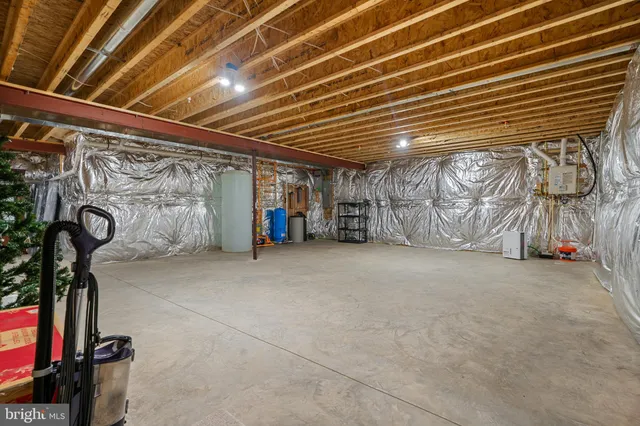 a kitchen with a dining table chairs refrigerator and cabinets