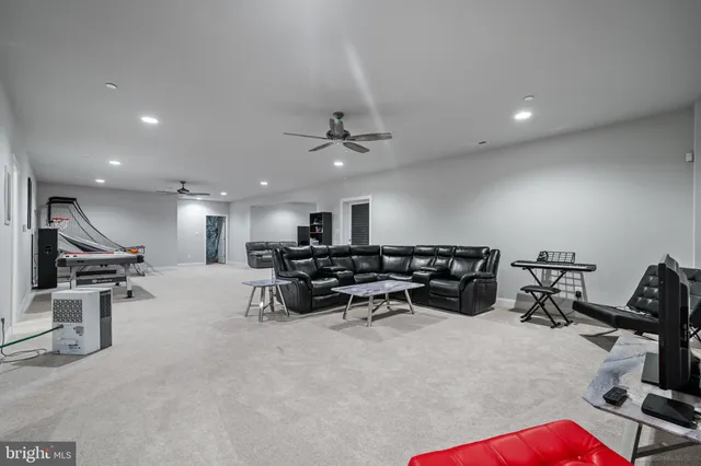a view of a dining room with wooden floor a fireplace and painted walls