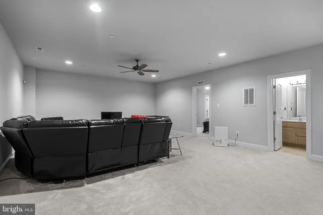 a en suite bathroom with a granite countertop sink and a mirror