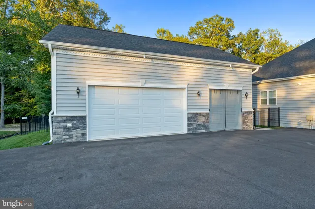 an aerial view of a house with swimming pool and garden