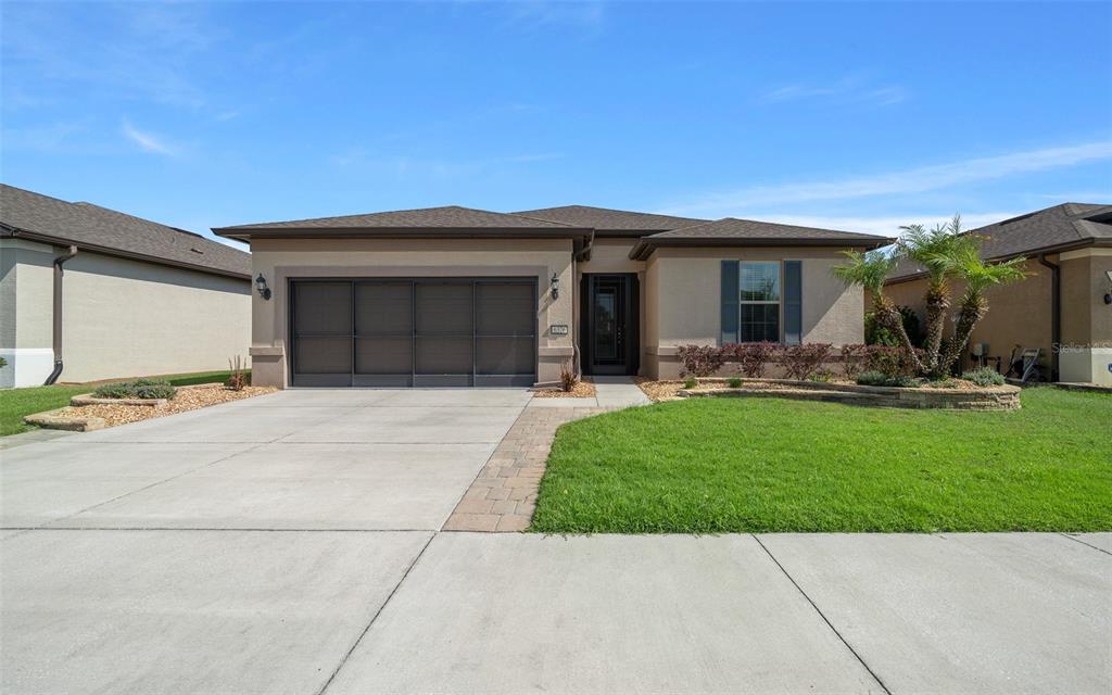 6376 Southwest 97th Terrace Road Ocala, FL 34481 - Photo 1 of 1 a front view of a house with patio