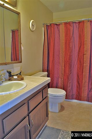 3485 Gulling Road Reno, NV 89503 - Photo 6 of 8 a bathroom with a sink a toilet and a mirror