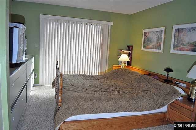 3485 Gulling Road Reno, NV 89503 - Photo 7 of 8 a bedroom with a bed and a flat tv screen on dresser