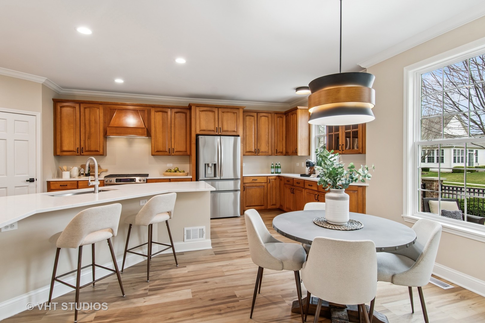 3607 Greystone Avenue Naperville, IL 60564 - Photo 11 of 59 a kitchen with stainless steel appliances granite countertop a dining table chairs and white cabinets