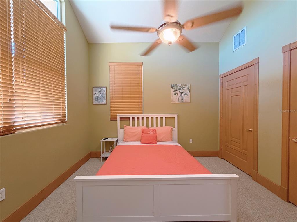 4421 Reaves Road Kissimmee, FL 34746 - Photo 13 of 100 a bedroom with a bed and a chandelier