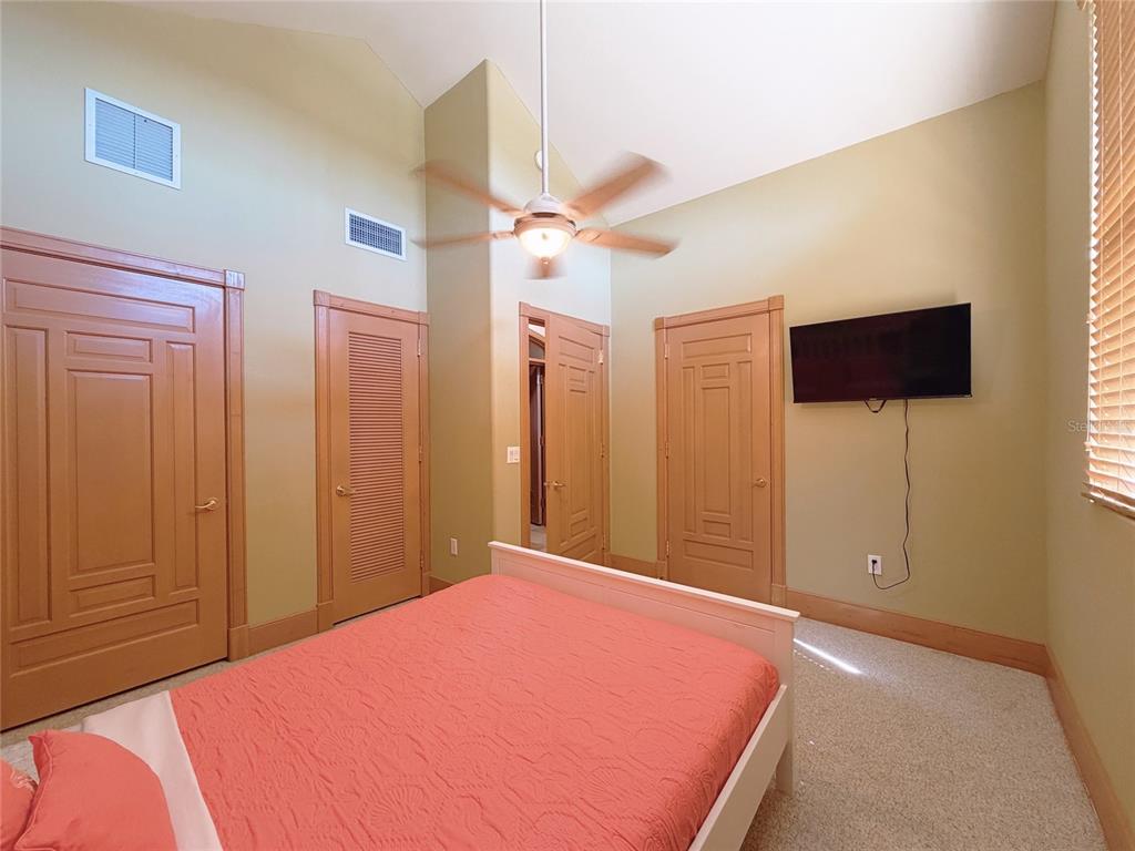 4421 Reaves Road Kissimmee, FL 34746 - Photo 14 of 100 a bedroom with a bed and a chandelier