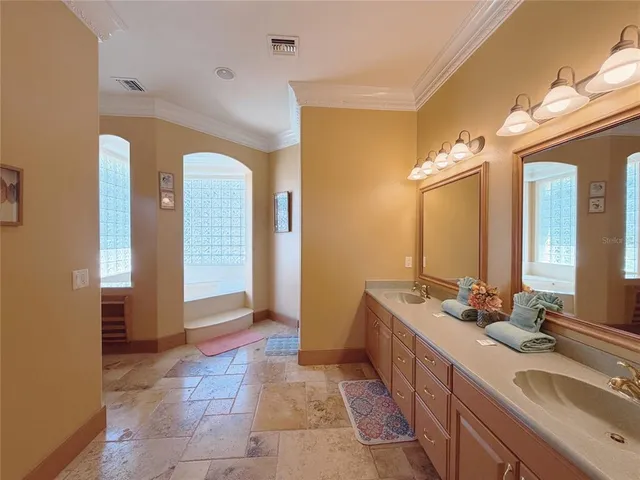 a kitchen with stainless steel appliances granite countertop a sink a stove and a refrigerator