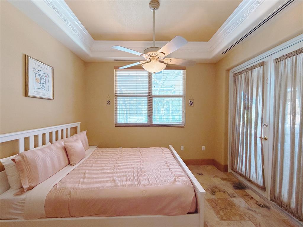 4421 Reaves Road Kissimmee, FL 34746 - Photo 30 of 100 a bedroom with a large bed and a chandelier
