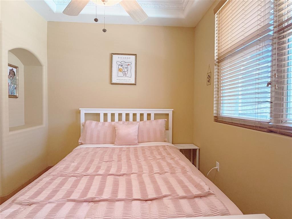 4421 Reaves Road Kissimmee, FL 34746 - Photo 31 of 100 a bedroom with a large bed and a window