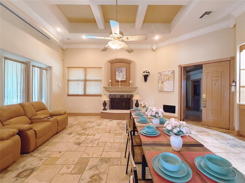 4421 Reaves Road Kissimmee, FL 34746 - Photo 48 of 100 a living room with furniture a fireplace and a table