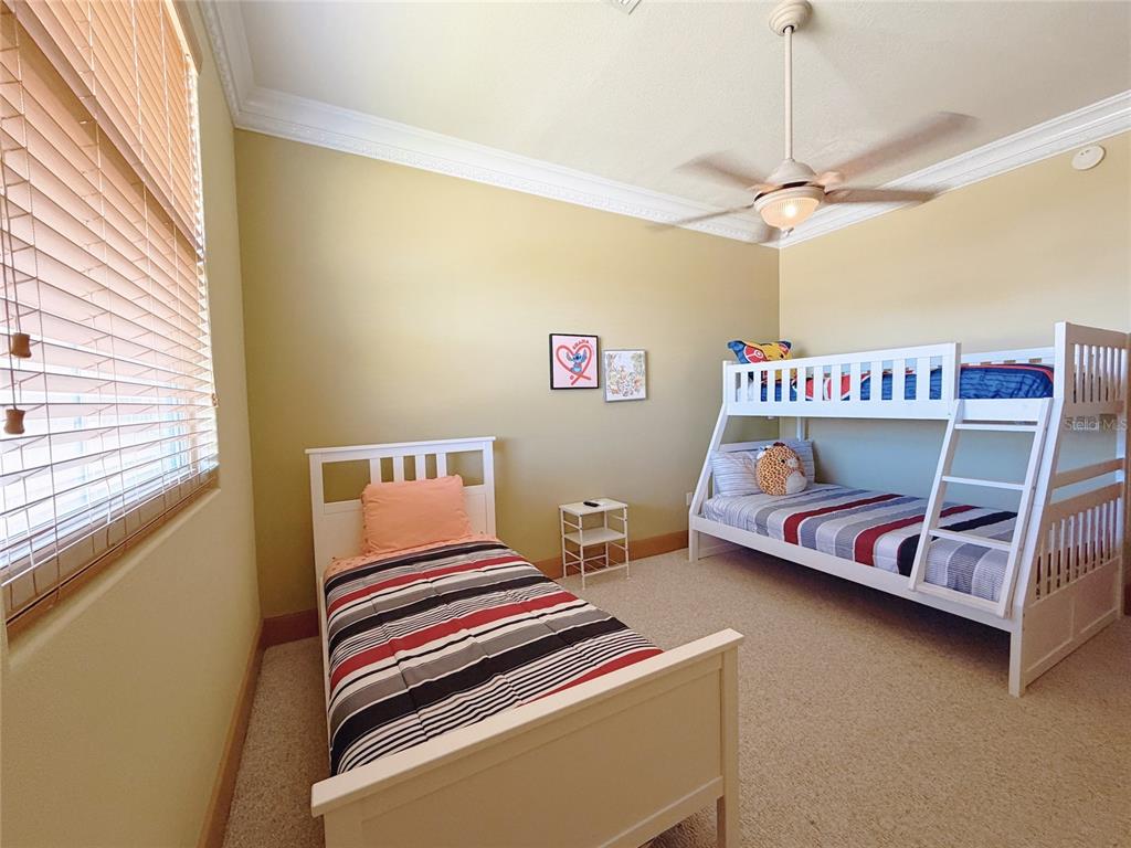 4421 Reaves Road Kissimmee, FL 34746 - Photo 63 of 100 a bedroom with a bed and a chandelier