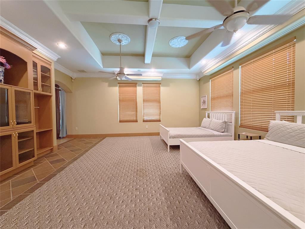 4421 Reaves Road Kissimmee, FL 34746 - Photo 69 of 100 a spacious bedroom with a large bed and a window