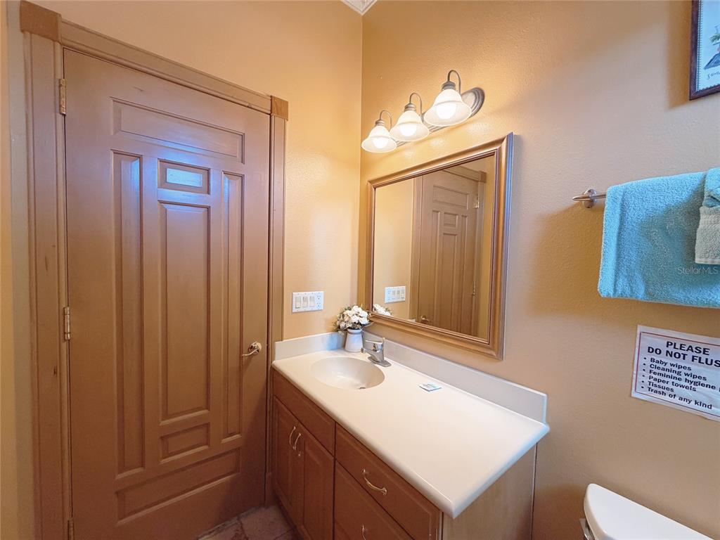 4421 Reaves Road Kissimmee, FL 34746 - Photo 10 of 100 a bathroom with a sink vanity and a mirror