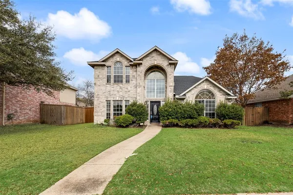 a view of a house with a big yard and large trees