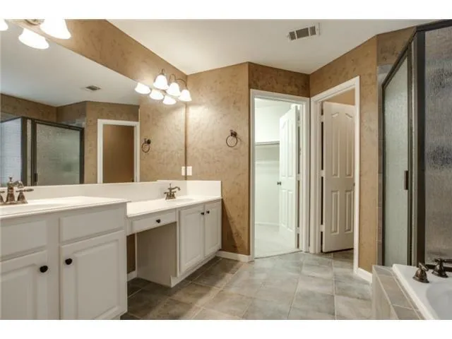 a bathroom with a double vanity sink mirror and double