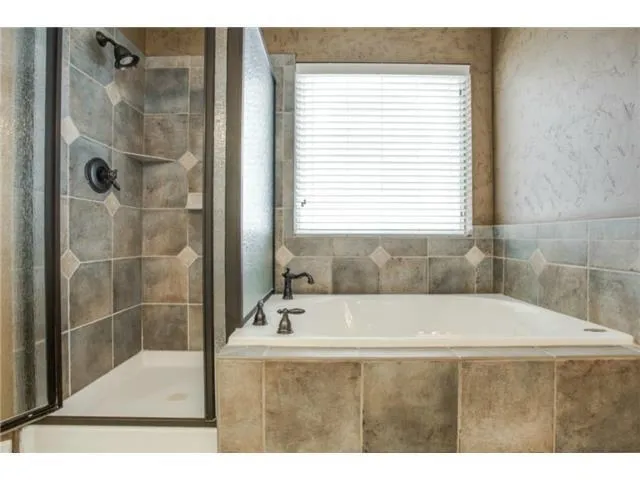 a bathroom with a bathtub and a shower