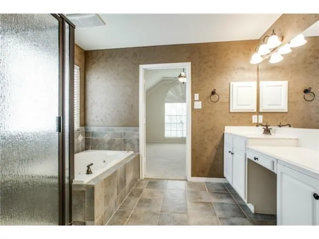 a bathroom with a sink a mirror and a bathtub