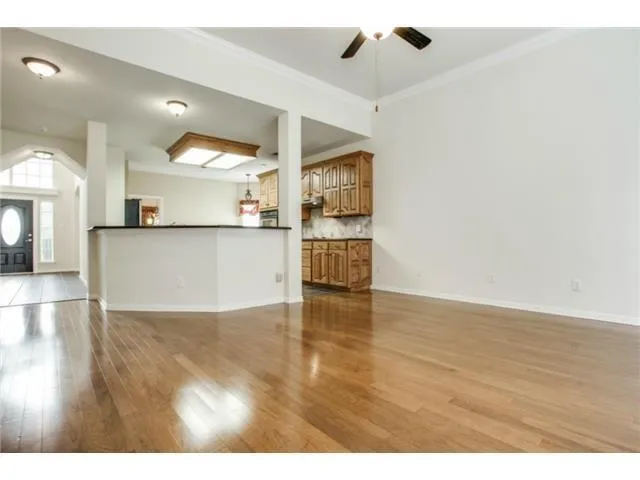 a view of a kitchen with a sink and a refrigerator