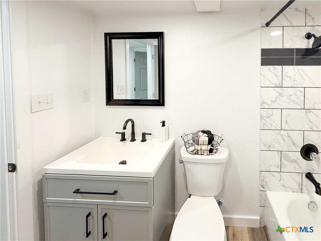 215 East Valley Road Harker Heights, TX 76548 - Photo 11 of 16 a bathroom with a sink a toilet and a mirror