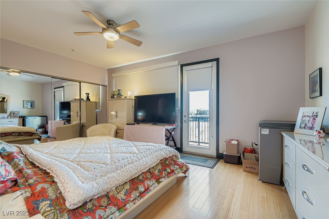 2755 West Pebble Road, Unit 319 Las Vegas, NV 89123 - Photo 11 of 29 Bedroom featuring access to outside, light wood-style floors, a closet, and ceiling fan