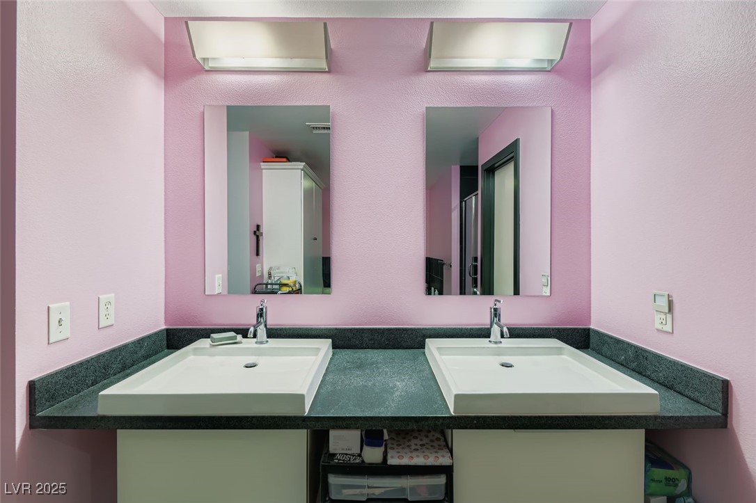 2755 West Pebble Road, Unit 319 Las Vegas, NV 89123 - Photo 12 of 29 Full bath featuring a textured wall and double vanity