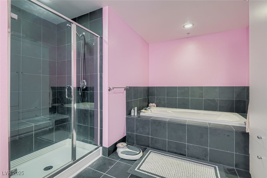 2755 West Pebble Road, Unit 319 Las Vegas, NV 89123 - Photo 13 of 29 Bathroom with tile patterned floors, a bath, and a shower stall