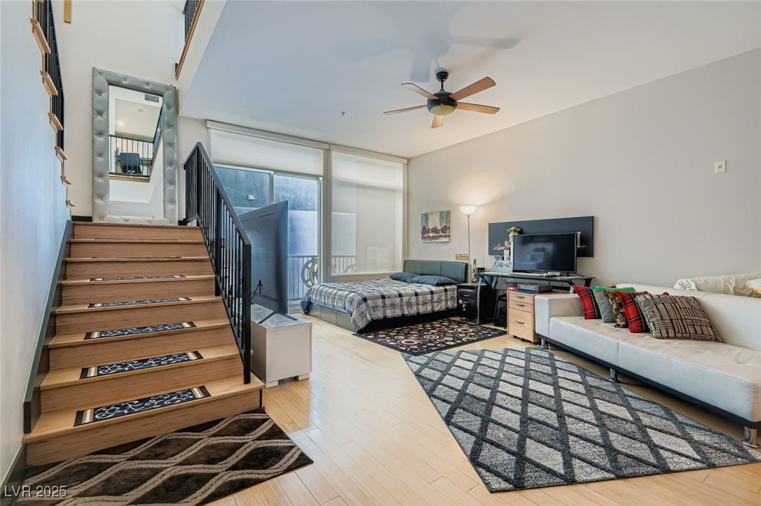 2755 West Pebble Road, Unit 319 Las Vegas, NV 89123 - Photo 6 of 29 Bedroom with light wood finished floors, expansive windows, and ceiling fan
