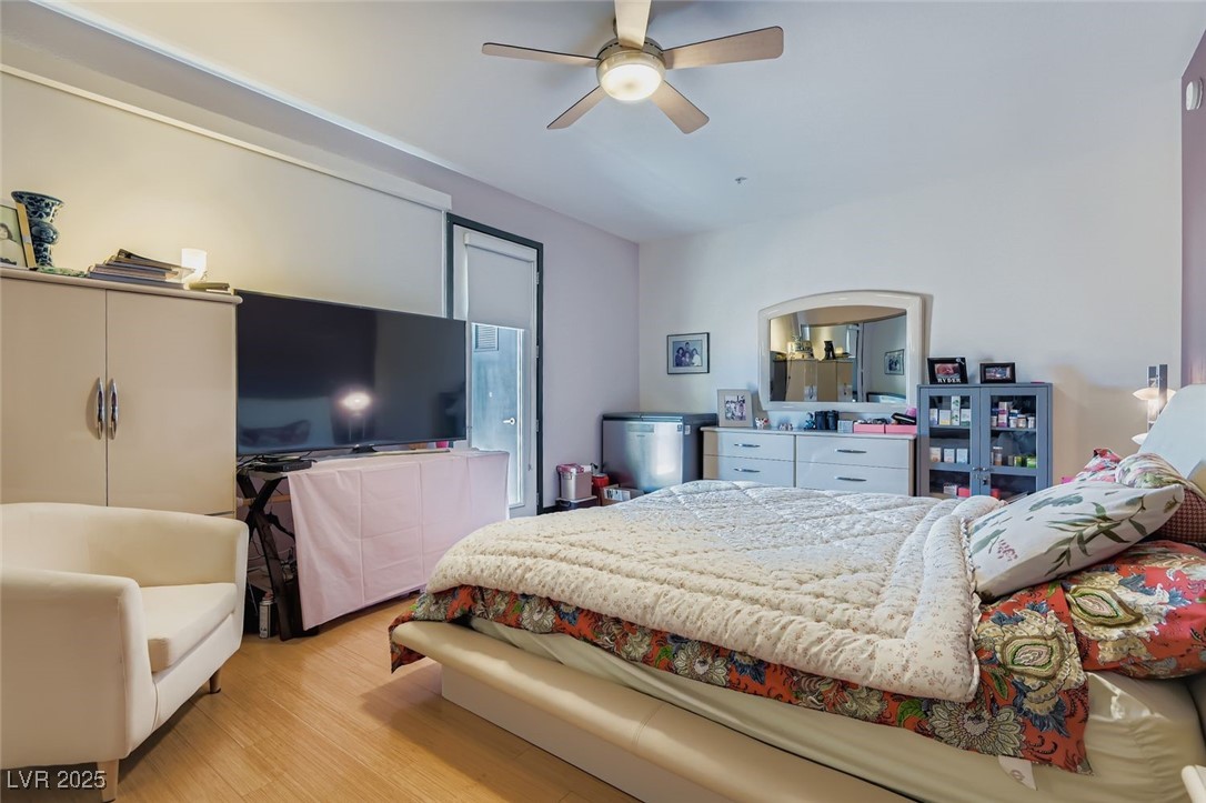 2755 West Pebble Road, Unit 319 Las Vegas, NV 89123 - Photo 9 of 29 Bedroom featuring light wood-style floors and ceiling fan