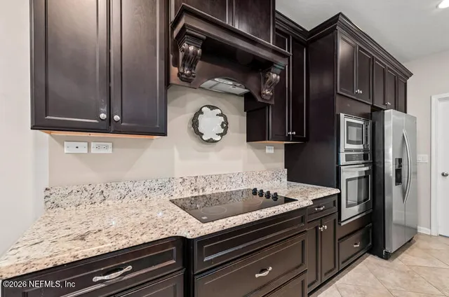 a kitchen with granite countertop stainless steel appliances and cabinets