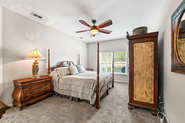 a bedroom with bed and a window