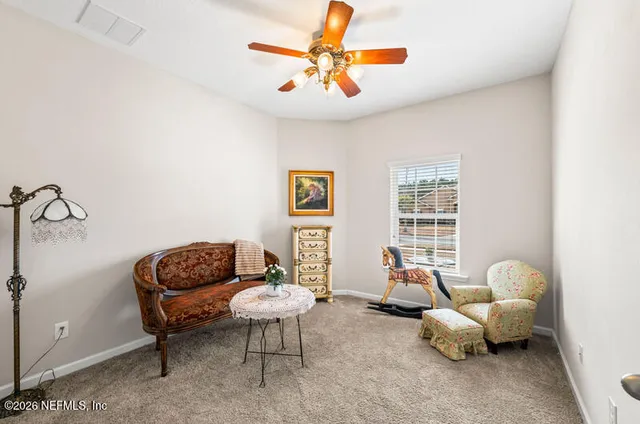 a living room with furniture and windows