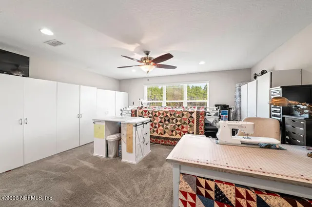a living room with furniture a flat screen tv and a table