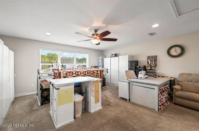 a living room with kitchen island furniture and a clock