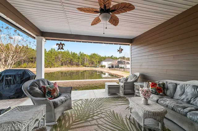 a balcony with furniture and a large window