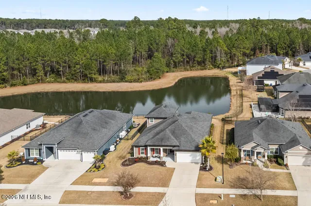 an aerial view of a house with a lake view