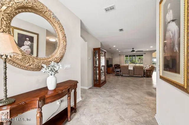 a living room with furniture and a mirror