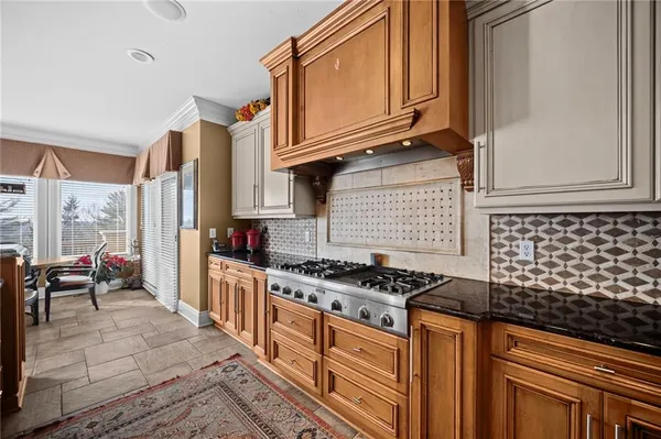 a kitchen with stainless steel appliances granite countertop a stove a sink and dishwasher