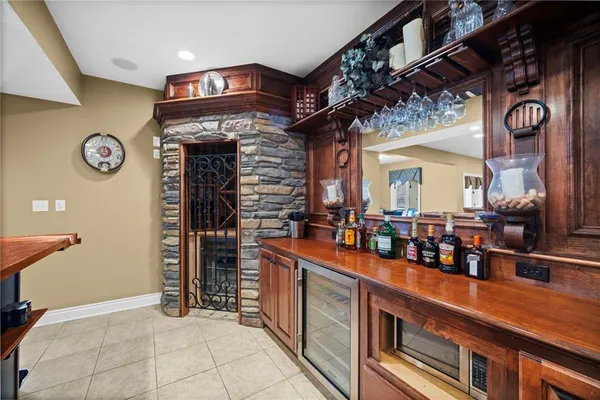a view of a kitchen with fridge and wooden floor