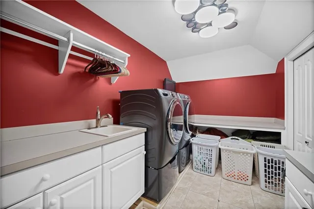 a bathroom with a tub sink shower and mirror