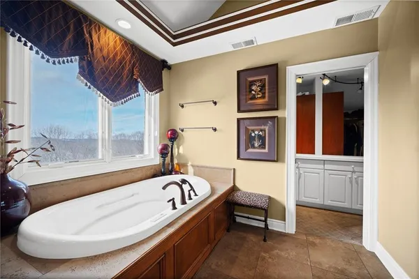 a bathroom with a tub and a sink