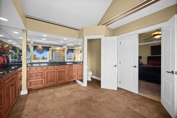 a large kitchen with a refrigerator and a sink