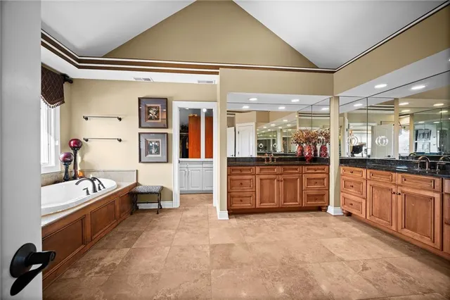 a bathroom with a granite countertop toilet and sink