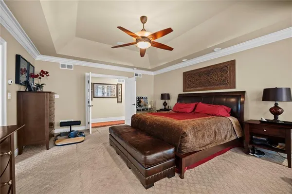 a bedroom with a bed furniture and ceiling fan