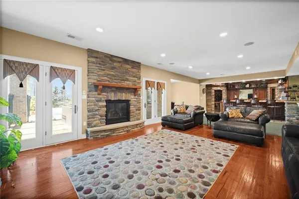 a living room with furniture rug and wooden floor