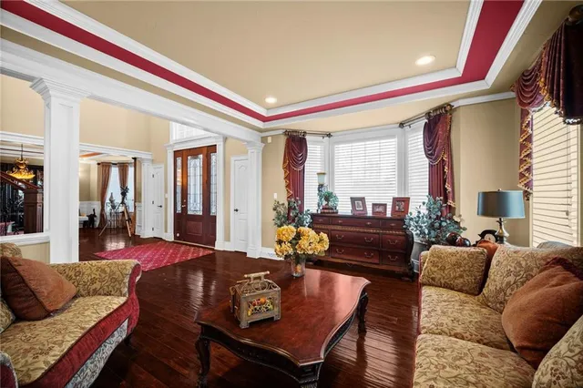a kitchen with granite countertop a table chairs sink and refrigerator