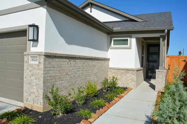 a view of front door and potted plants
