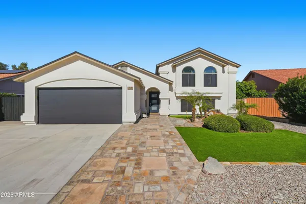 a front view of a house with yard and green space
