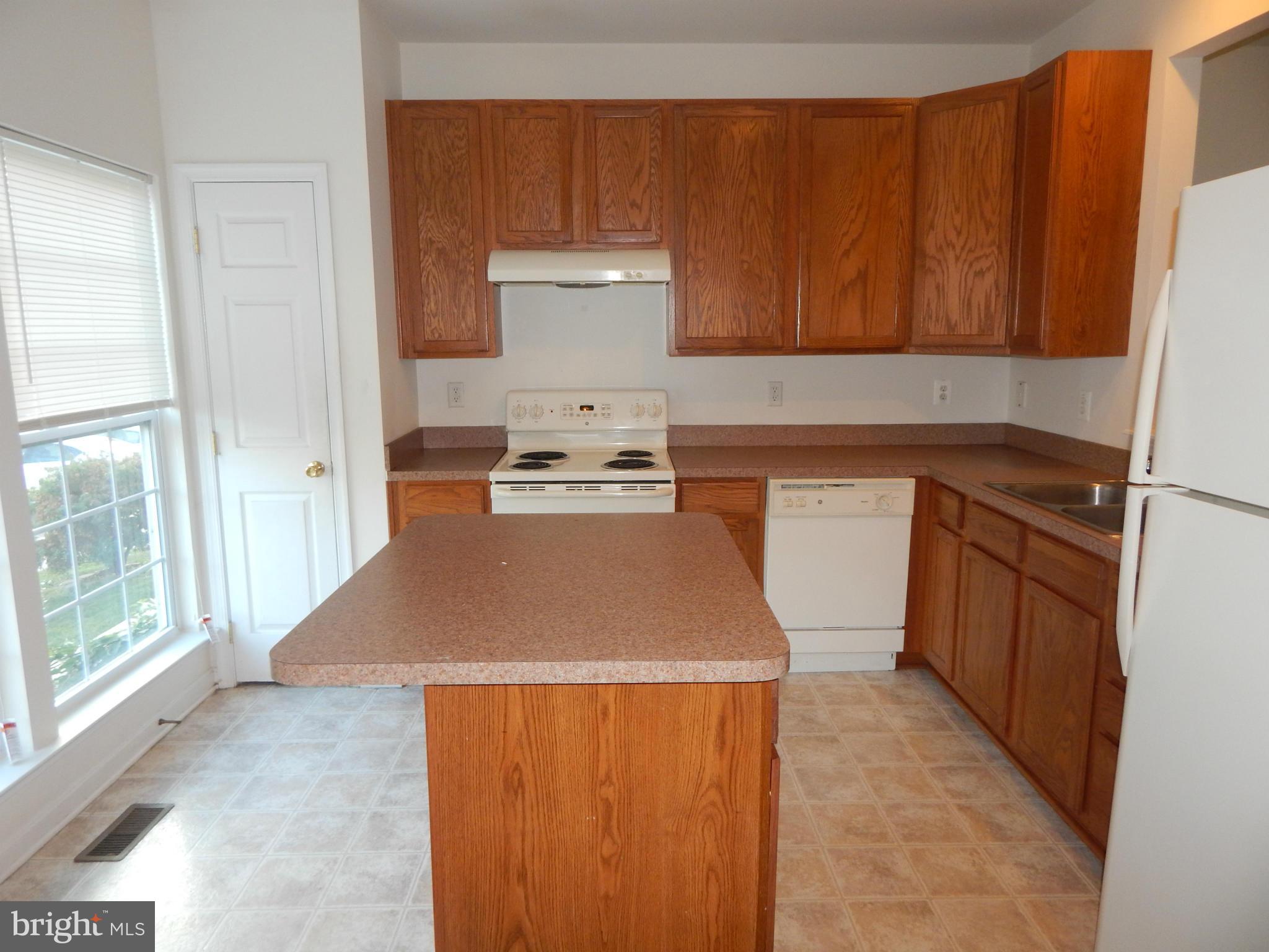 1724 Waltman Road Edgewood, MD 21040 - Photo 3 of 30 a room with wooden cabinets washer and dryer