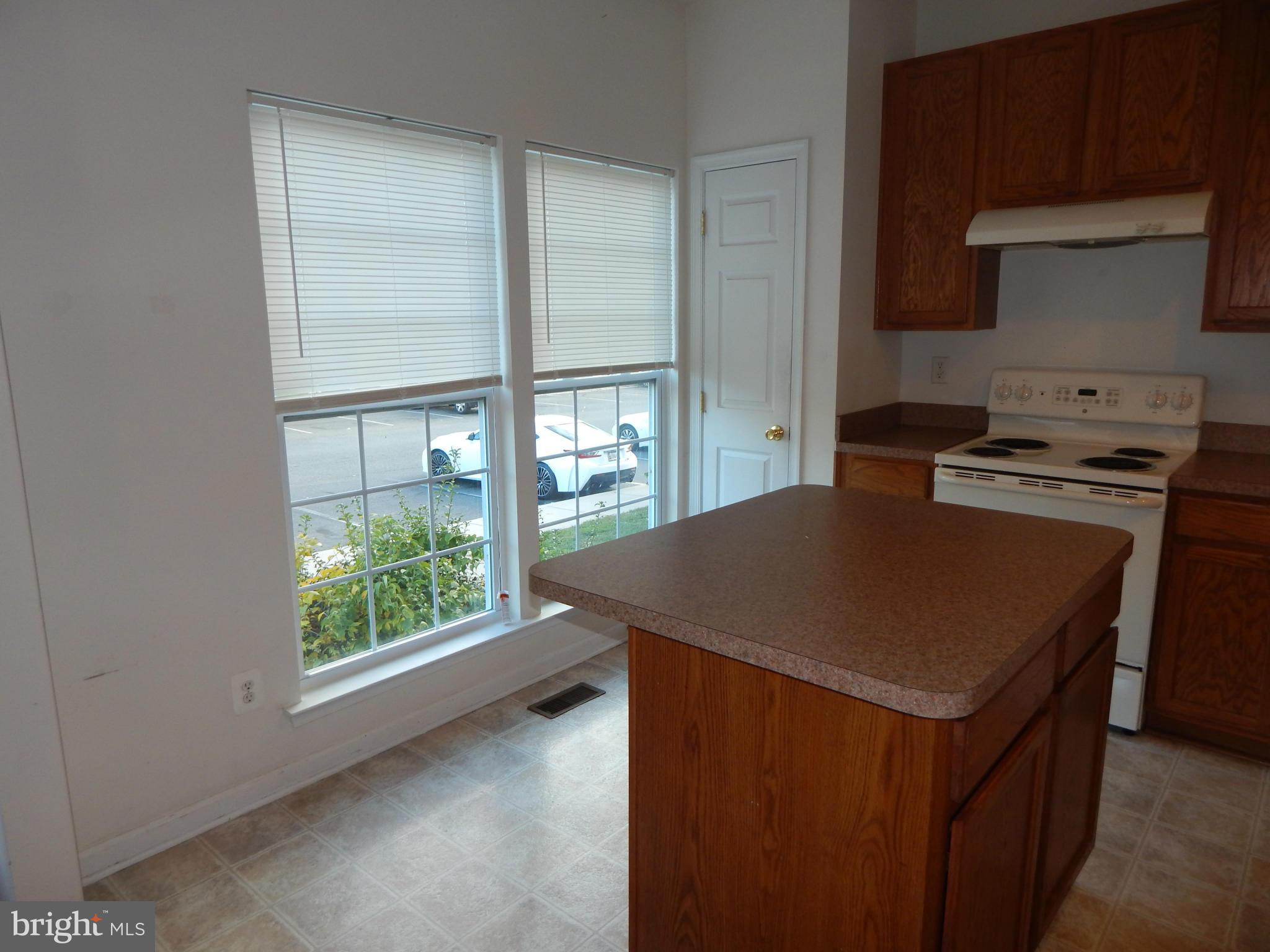 1724 Waltman Road Edgewood, MD 21040 - Photo 4 of 30 a kitchen with a stove a sink a refrigerator and window